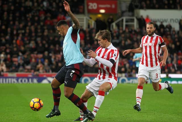 Andre Gray is fouled by Marc Muniesa