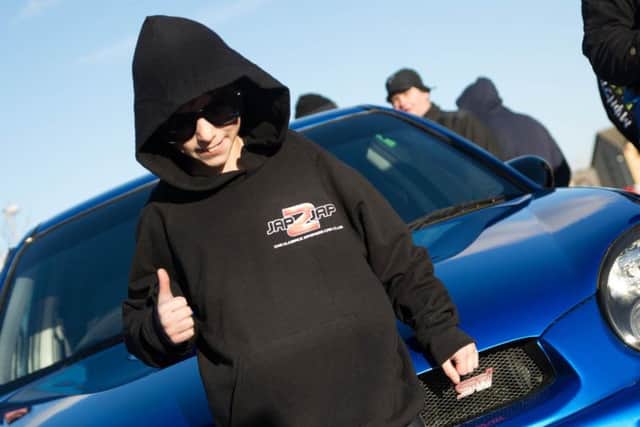 Tyler gives the thumbs up after his ride in a Subaru