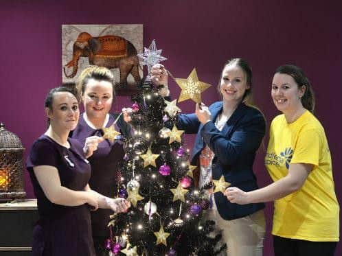 Olympian Sophie Hitchon (second from left) places the first fund-raising star to launch Inside Spa's charity Christmas appeal for Pendleside Hospice with (left to right) therapist Julie Hanson; Inside Spa manager, Beverley Hinningan; and Hospice fund raiser, Vikki Bazeak.