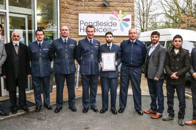 Shabz with his award alongside his father, brothers, and colleagues at Pendleside Hospice.