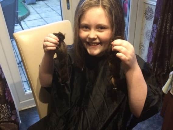 Katie Heffernan with the hair she had cut to donate to the Little Princess Trust charity to make wigs for children going through cancer treatment