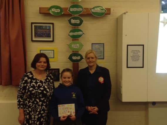 Olivia with her award winning card and Burnley's MP Julie Cooper (left) and  representative of Tesco who were involved with the judging of the competition.