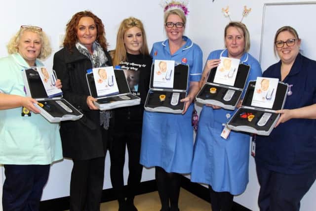 Christy Smith and mum Avril Pilling join nurses from Royal Blackburn Teaching  Hospitals Childrens Ward to hand over five sleep apnoea machines (s)