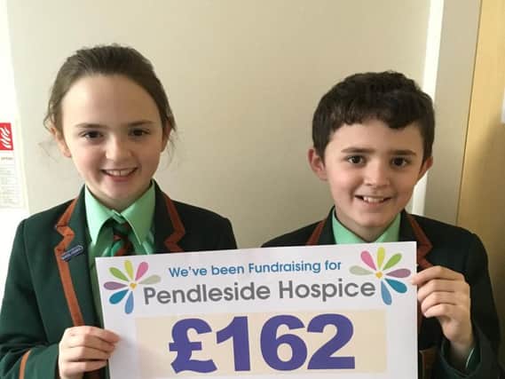 Twins Ruairi and Maisie Dillon with their cheque for the money their cake sale raised for Pendleside Hospice
