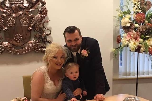 Georgia and Emmott Garnett with their son Arlo after tying the knot at Burnley Register Office