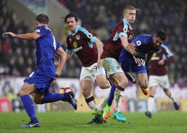 Joey Barton and Ben Mee try to win the ball