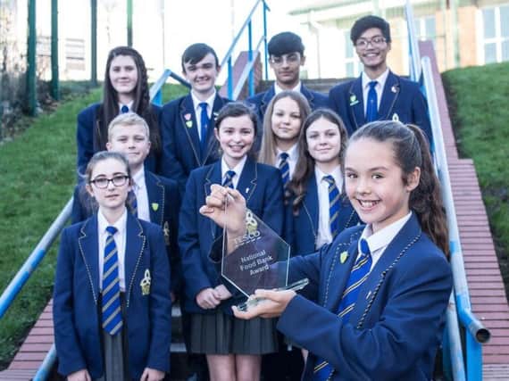 Blessed Trinity RC College students pictured with the award they received for taking part in the Tesco Neighbourhood Food challenge.