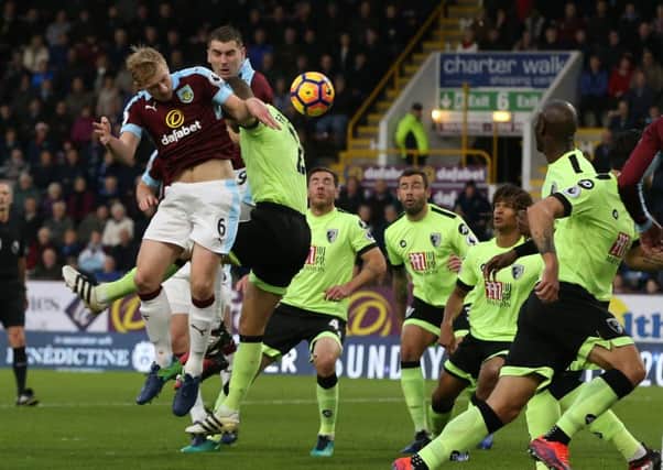 Burnley defender Ben Mee heads for goal against AFC Bournemouth