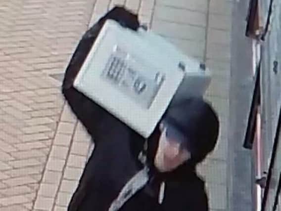 Police want to find this man who stole a safe from a popular and long established shop in Burnley Market Hall.