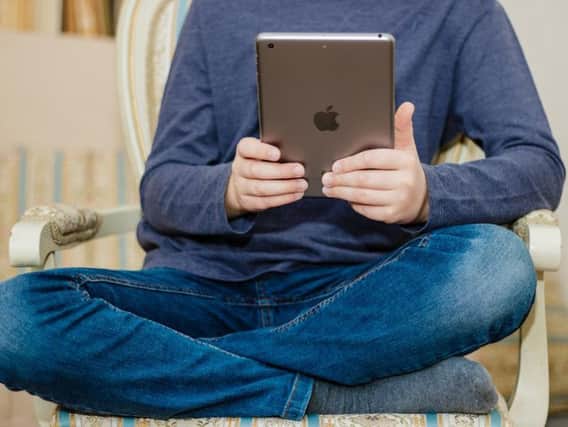 Teenager using an Apple iPad. Shutterstock