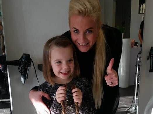 Lexi Hunt (six) with stylist Jodie Forrest at Padiham's Vanilla hair salon. Lexi had her hair cut and raised 350 for charity.