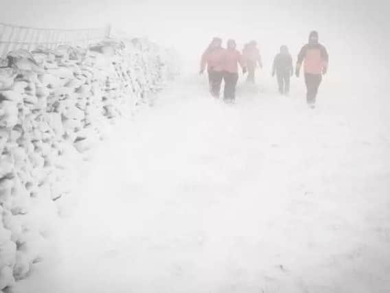 Rossendale and Pendle Mountain Rescue team guide the lost walkers to safety from Pendle Hill.