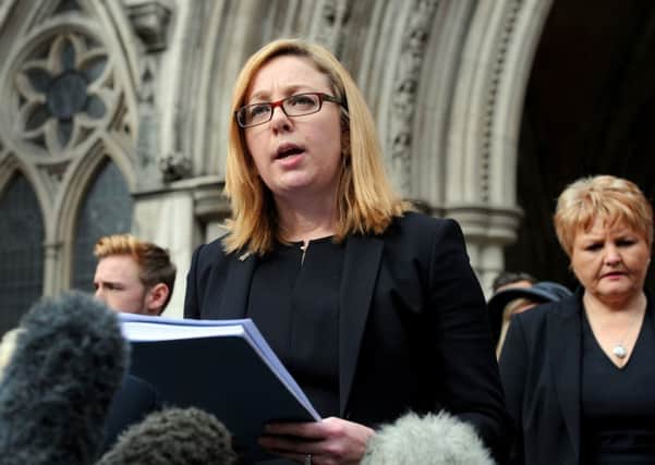 Kylie Hutchison from lawyer Irwin Mitchell reads out a statement on behalf of relatives outside the Royal Courts of Justice