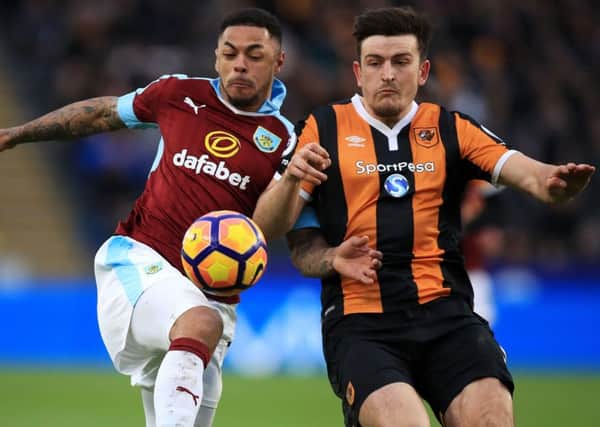 Burnley's Andre Gray (left) and Hull City's Harry Maguire battle for the ball during the Premier League match at the KCOM Stadium, Hull. PRESS ASSOCIATION Photo. Picture date: Saturday February 25, 2017. See PA story SOCCER Hull. Photo credit should read: Mike Egerton/PA Wire. RESTRICTIONS: EDITORIAL USE ONLY No use with unauthorised audio, video, data, fixture lists, club/league logos or "live" services. Online in-match use limited to 75 images, no video emulation. No use in betting, games or single club/league/player publications.