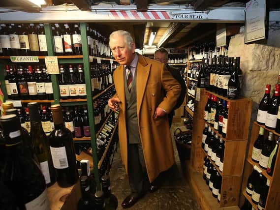 The Prince of Wales holds a glass of whisky at D Byrne & Co wine and spirit merchants, during a visit to the Clitheroe Food Festival