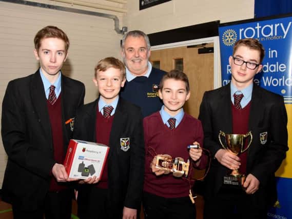 Foundation winners: St. Augustines pupils, from left to right Ben Brayton, Joseph Hughes-Gooding, Tomas Lloyd and Robert Holt with District Governor Malcolm Baldwin.