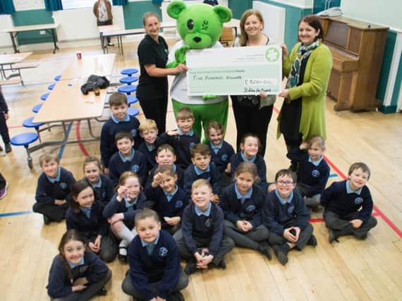 Teachers and pupils presented a cheque for 500 to staff from ward 84.