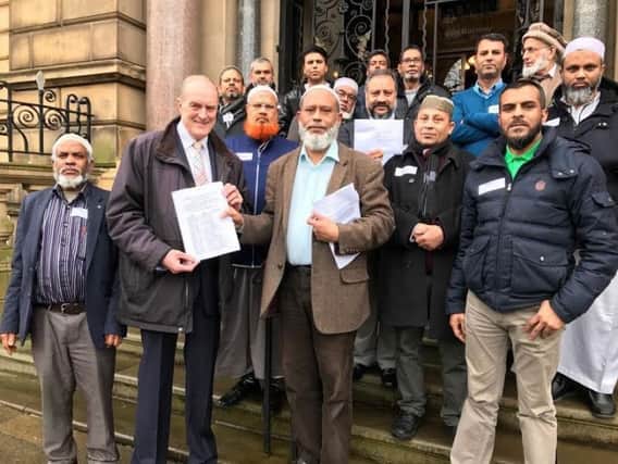 Community leaders and Stoneyholme residents present a petition to Coun. Gordon Birtwistle on the steps of Burnley Town Hall