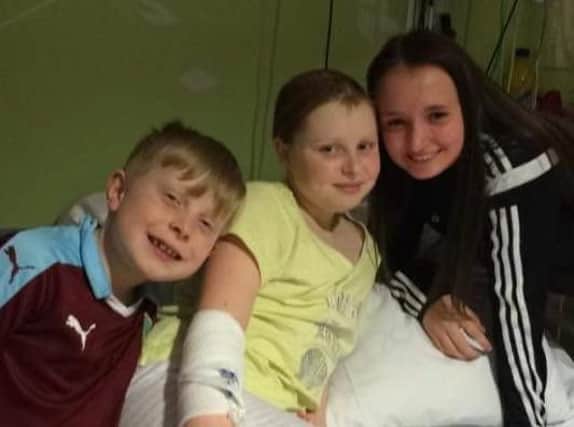Brave battler Morgan Hewitt, who has been diagnosed with leukaemia for the second time, with her brother Blake and cousin Kirsty.