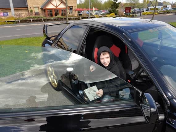 Tyler Norris-Sayers, who was hit in the eye with a firework last year,  is sitting pretty in one of the sports cars at the Jap2Jap meet in his honour.