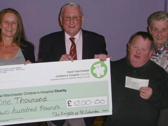 (From left:) Phillipa Boyd (Royal Manchester Children's Hospital Charity), Trevor Ireland (KSC Council 110 Grand Knight), David, and Mary (Handicapped Children's Fellowship).
