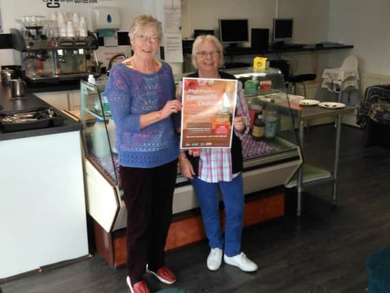 Volunteers Jackie Shaw and Jean Duff advertising Brierfield Action in Community's recipe event. (s)