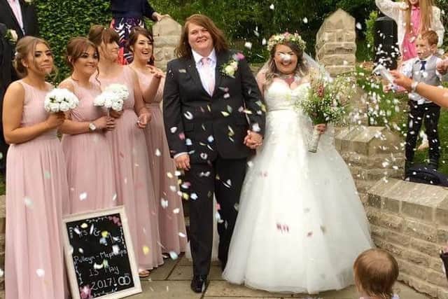 Newly weds Lizzie Pulleyn and Kim McPhillips celebrate with their bridesmaids after becoming the first gay couple to be married at Padiham's Nazareth Unitarian Chapel.