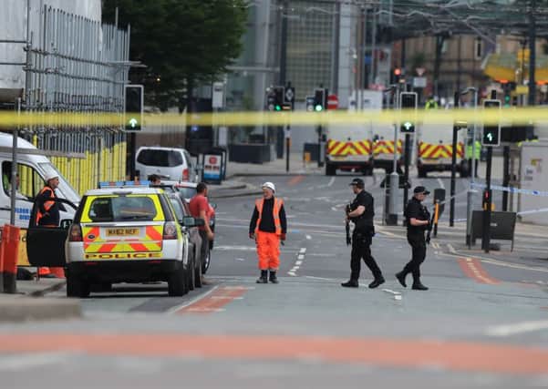 Police close to the Manchester Arena the morning after a suspected terrorist attack at the end of a concert by US star Ariana Grande left 22 dead