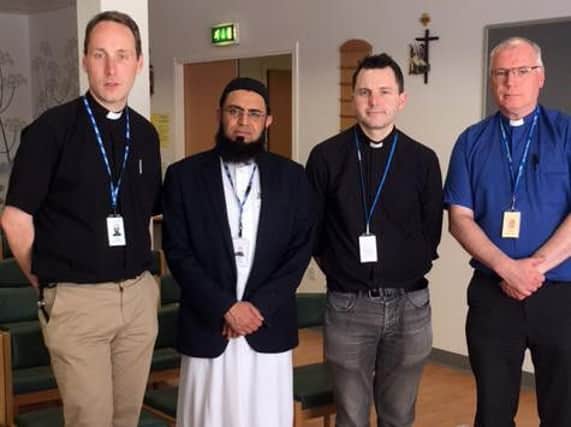 Rev. David Anderson, Imam Fazal Hassan, Father Frankie Mulgrew and Father Jim Lochhead after the remembrance service for victims of the Manchester bombing tragedy.