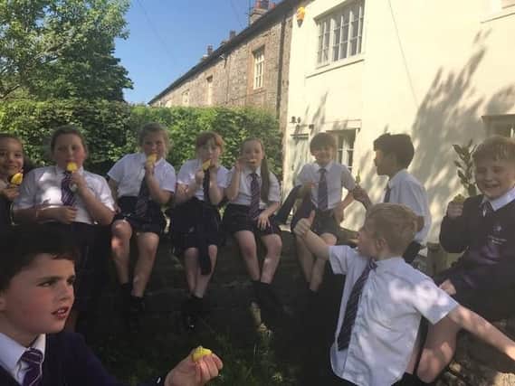 Children from St Mary Magdalene's RC Primary School, Burnley enjoy the ice lollies dished out to them by two decorators who came to their aid when their coach broke down during a day out.