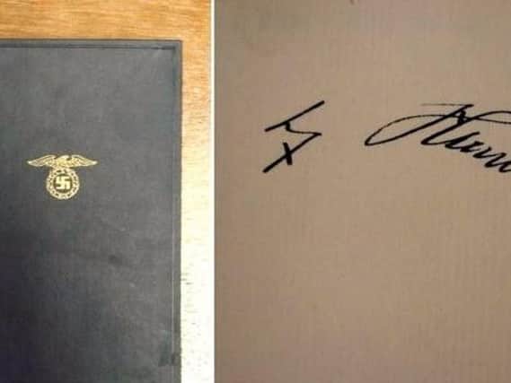 The blue cloth-covered 1935 edition bears the Nazi dictator's signature on the front fly leaf.