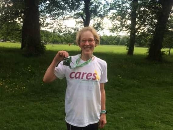 Sarah Ridehalgh shows off the medal she was awarded with for being the second fastest female in the Burnley 10k which she ran to raise money for the charity CARES.