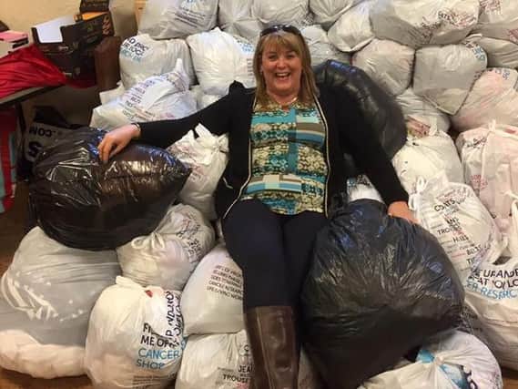 Angela Fielden with bags of clothes filled by Slimming World members in aid of Cancer Research UK. (s)