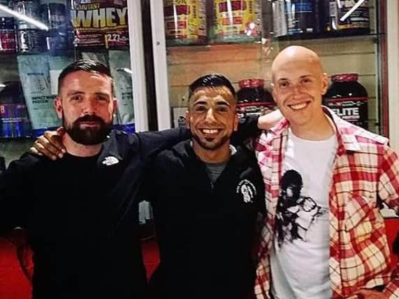 Tariq Khan (centre) with friends Kris Scholes (right) and James McDonough at the community event at Tariq's gym the Muscle Factory.