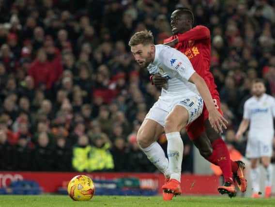 Charlie Taylor vies for possession with Liverpool's Sadio Mane