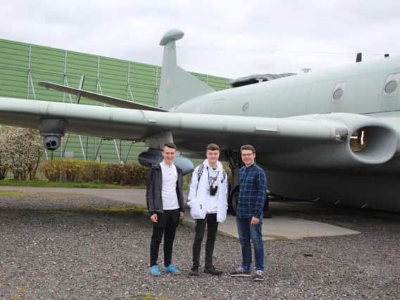 Advanced aeronautical apprentices Andy Heighway, Thomas Curran and Ellis Smith in front of the Nimrod