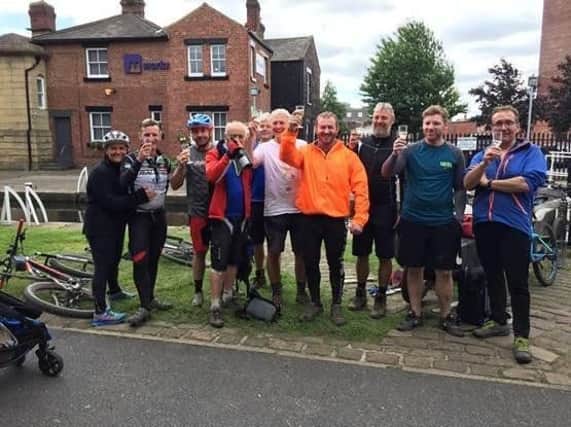 Champagne at the ready for some of the riders from Worsthorne Mountain Bike Club at the end of their epic bike ride along the Leeds to Liverpool canal.