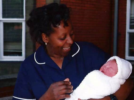 Midwife Thelma Blake with one of the many babies she delivered during her career