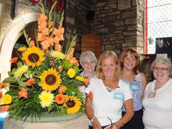 Organisers at  a previous Worsthorne Art and Crafts fair admire a blooming display of sunflowers.