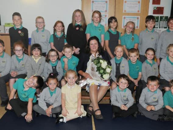Teacher Anne Battersby, who has retired this week after 28 years at Ightenhill Primary School, Burnley, surrounded by some of her students