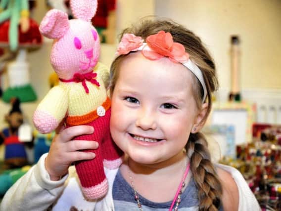 Daisy Jones (four) chooses her favourite knitted toy from the large selection on offer at the 43rd Worsthorne Art and Crafts Fair.
