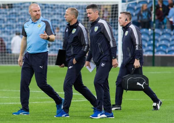 Sean Dyche discusses with his staff. Photo: Kelvin Stuttard
