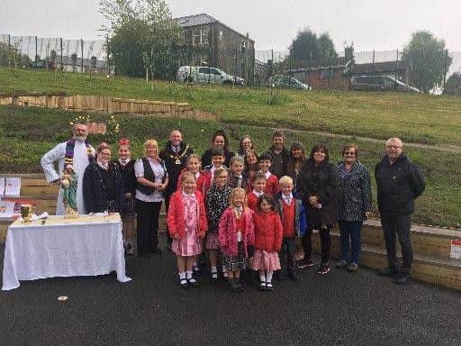 Fr Brian Kealey (far left) at the recent opening of the peace garden at Christ the King Primary School with pupils, teachers and civic dignitaries