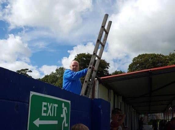 Steve Wilkes tries to get round his suspension on Saturday by watching from a ladder outside the Arbories