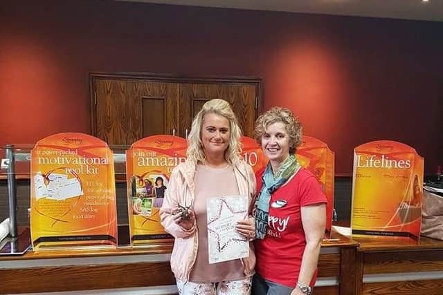 A delighted Adele receives her Woman of the Year award from Slimming World consultant Caroline Griffiths.
