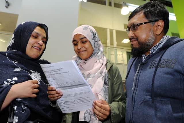 Thomas Whittam Sixth Form College, Burnley, students Amina Ansari who gained two A*'s and one B with mum Hafsa Khanom and uncle Dr Muhammad Al-Amin.