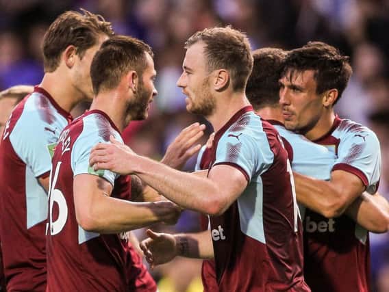 The Burnley players celebrate the opening goal