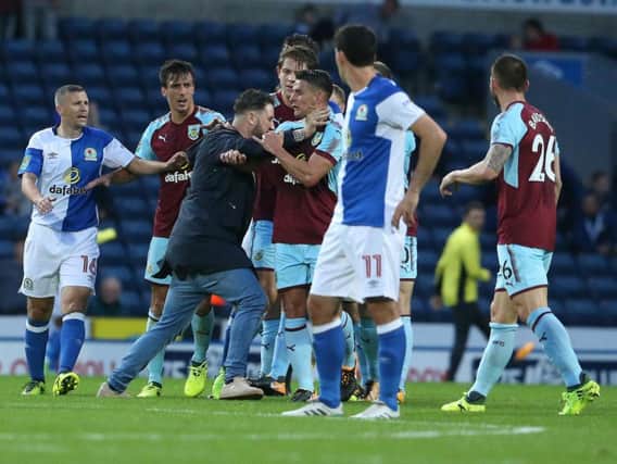 The pitch invader grabbed Clarets midfielder Ashley Westwood by the neck