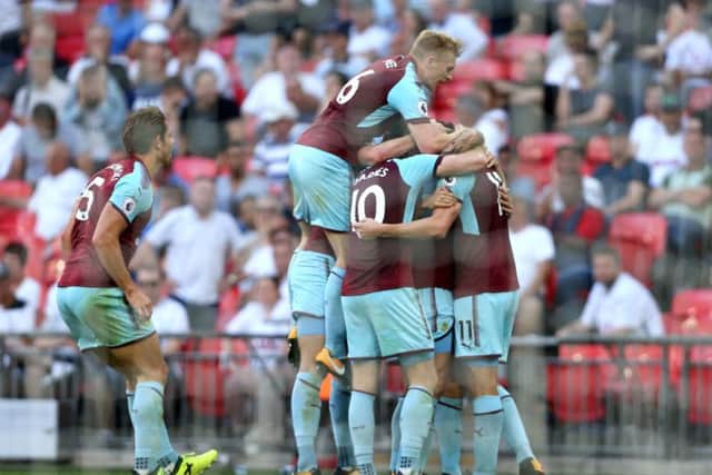 Chris Wood is flanked by his new teammates following his late equaliser at Wembley