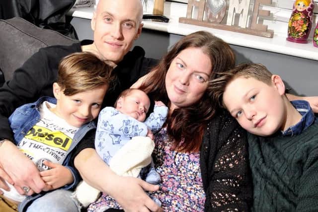 Mel after the birth of her baby, Sonny, with her partner Kris Scholes and their two older sons Reece and Riley.